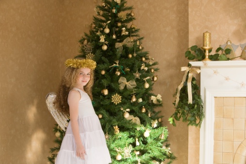 young_girls_dressed_as_angle_standing_by_tree