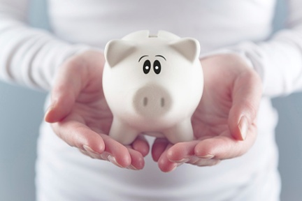 woman-holding-piggy-bank-524156467